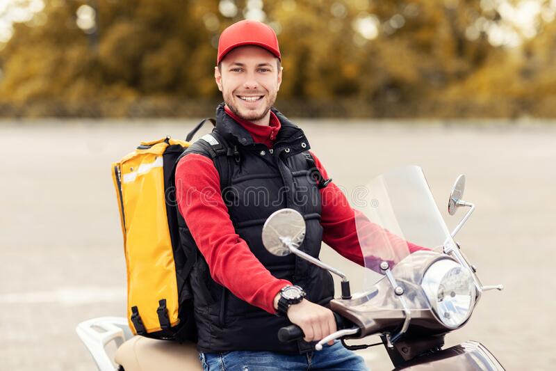 48499843346559happy-delivery-man-yellow-backpack-riding-moto-scooter-outdoors-courier-career-happy-delivery-man-yellow-backpack-riding-193948803.jpg